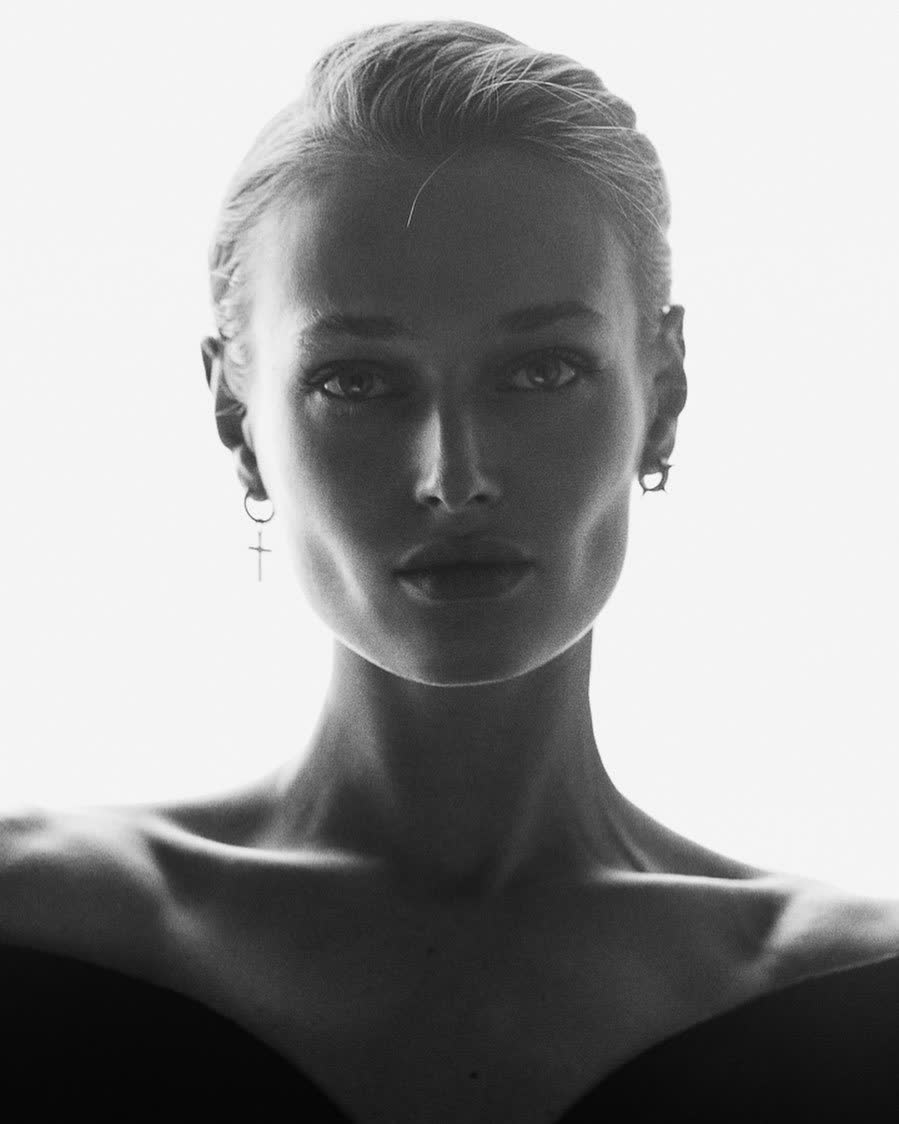 Anastasiia Koval in black and white, shoulders bare, meeting the camera with a direct, unhurried gaze.