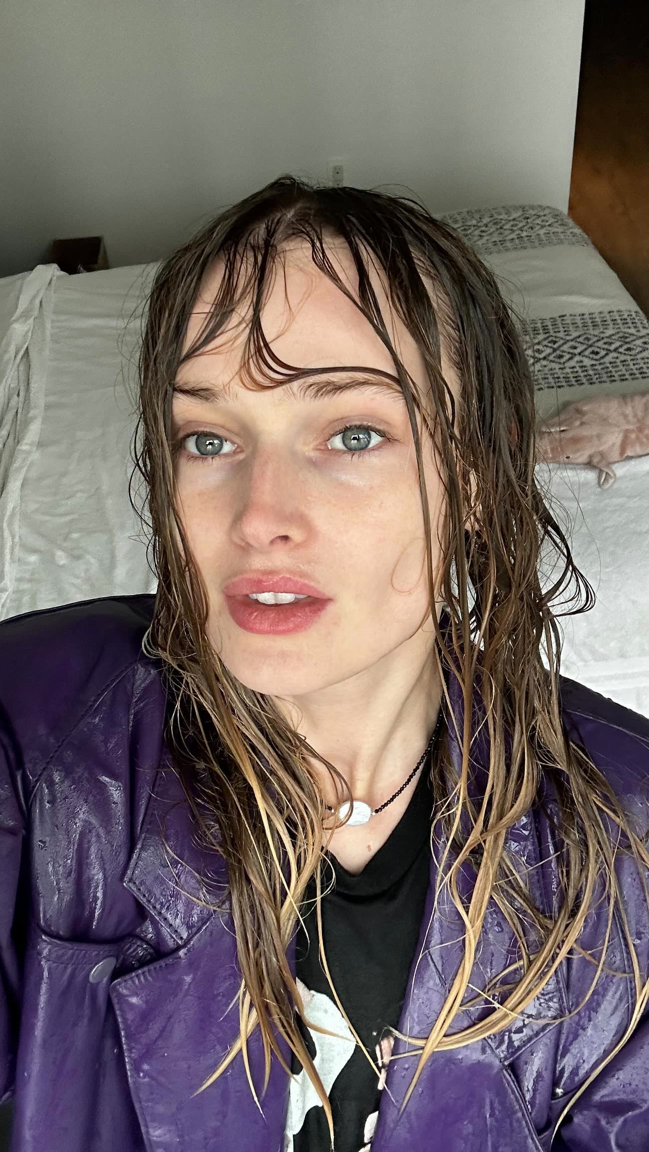 Anastasiia Koval, hair wet, in a dark jacket, looking directly into the lens.