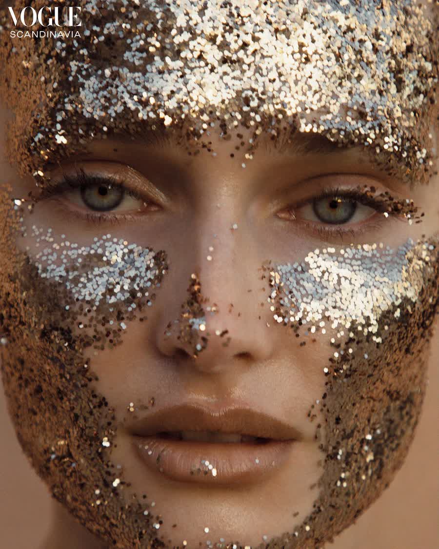 Beauty frame of Anastasiia Koval with gold pigment across her cheekbones.